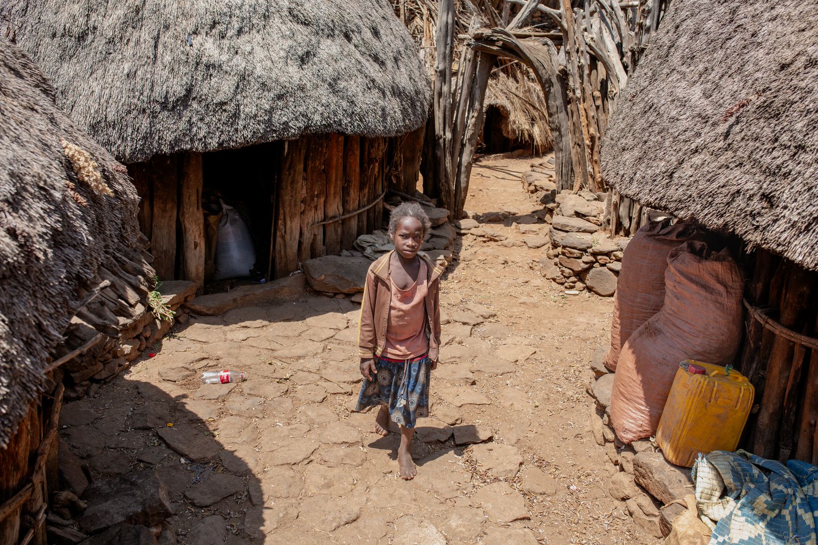 A child outside a home in a traditional Ethiopian village